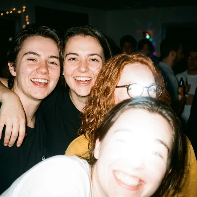 Four faces, a flash on the glasses — nothing says which person is you.